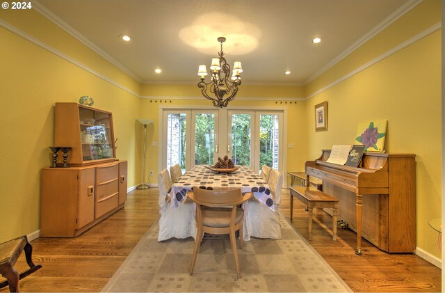 17130 Eastwood Ln, Brookings, OR 97415 - dining space with a chandelier, wood finished floors, recessed lighting, baseboards, and crown molding