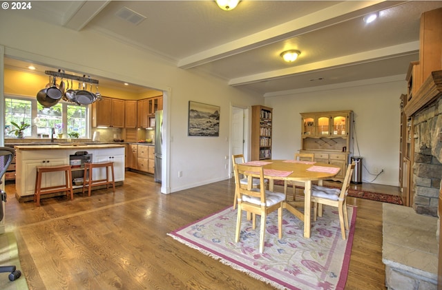 17130 Eastwood Ln, Brookings, OR 97415 - dining area with beamed ceiling, wood finished floors, and baseboards