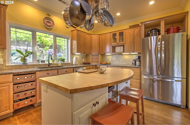 17130 Eastwood Ln, Brookings, OR 97415 - kitchen with freestanding refrigerator, butcher block counters, a sink, ornamental molding, and a kitchen island