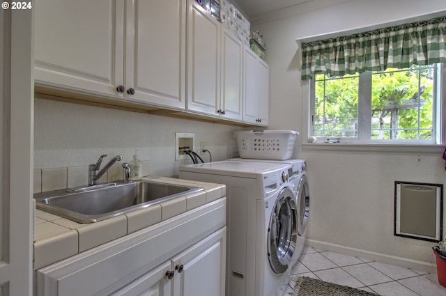 17130 Eastwood Ln, Brookings, OR 97415 - laundry area with cabinet space, washing machine and dryer, and light tile patterned floors