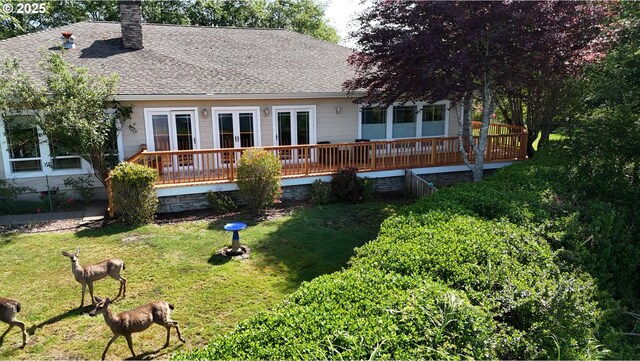 17130 Eastwood Ln, Brookings, OR 97415 - rear view of house with a wooden deck, french doors, a lawn, a shingled roof, and a chimney