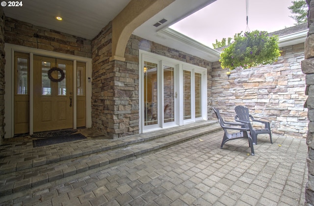 17130 Eastwood Ln, Brookings, OR 97415 - doorway to property featuring stone siding and a porch