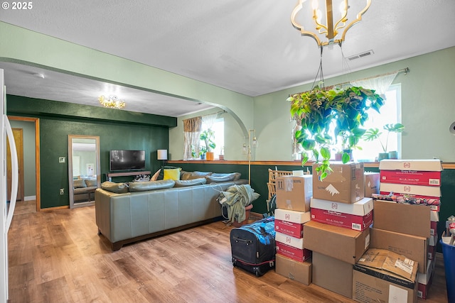 living area with a chandelier and wood finished floors