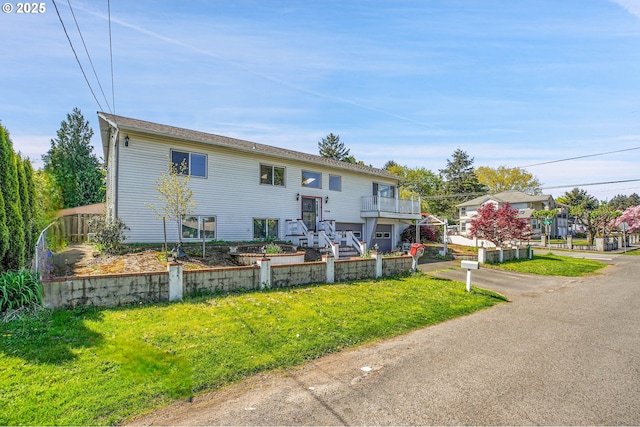 split foyer home with stairway and a front lawn