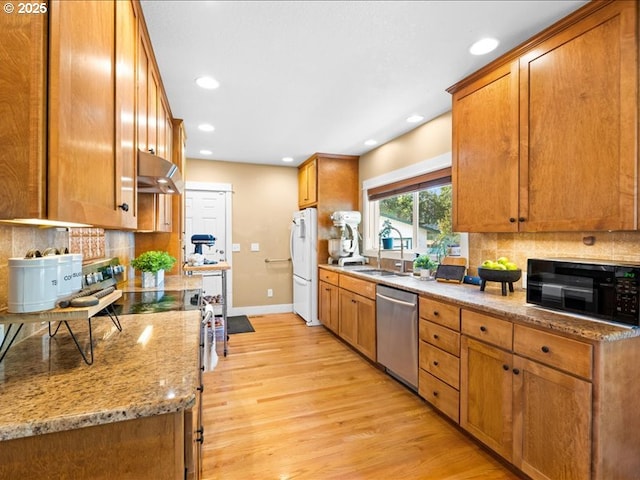 13283 NW Main St, Banks, OR 97106 - kitchen with dishwasher, black microwave, range hood, light wood-style floors, and brown cabinets