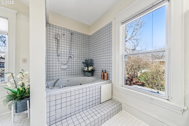 bathroom with a relaxing tiled tub, a healthy amount of sunlight, and tiled shower