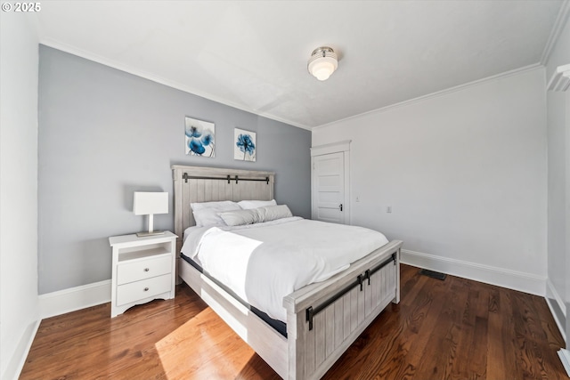 bedroom featuring baseboards, visible vents, ornamental molding, and dark wood-type flooring