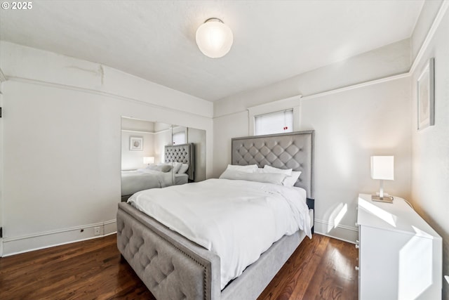 bedroom featuring dark wood-type flooring and baseboards