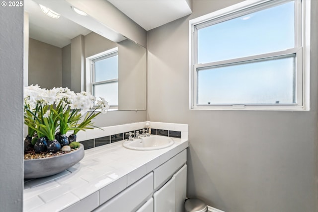 bathroom with plenty of natural light and vanity