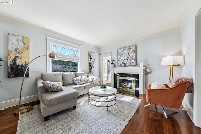 living room with ornamental molding, a fireplace with flush hearth, and dark wood-style floors