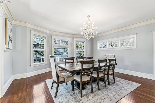 dining space with baseboards, wood finished floors, and ornamental molding