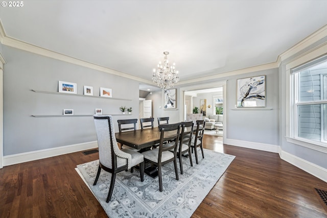 dining space with baseboards, visible vents, and wood finished floors