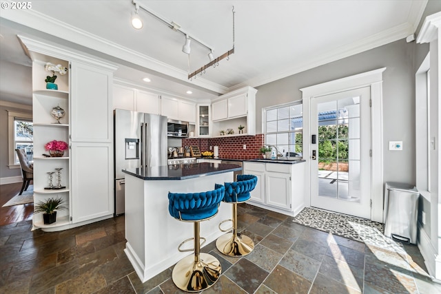 kitchen with stone tile floors, white cabinetry, appliances with stainless steel finishes, open shelves, and dark countertops