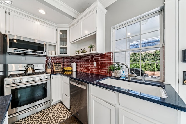 kitchen with tasteful backsplash, appliances with stainless steel finishes, white cabinetry, open shelves, and a sink