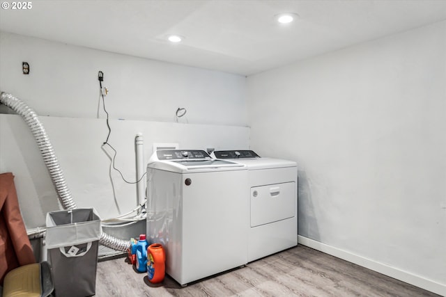 laundry room with recessed lighting, light wood-style flooring, separate washer and dryer, laundry area, and baseboards