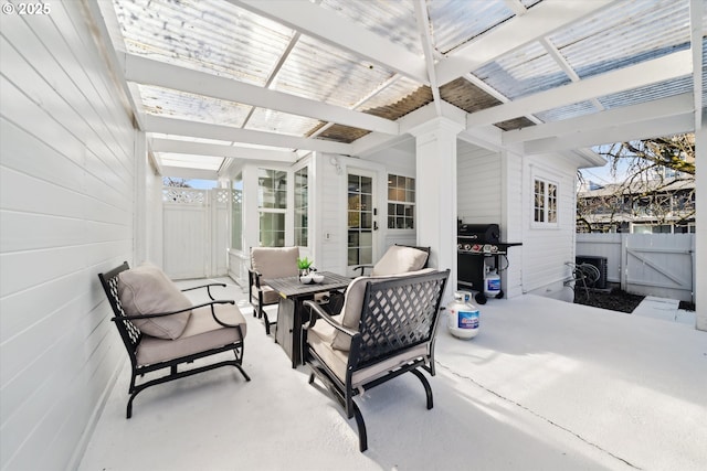 view of patio / terrace featuring an outdoor living space, grilling area, fence, and a gate