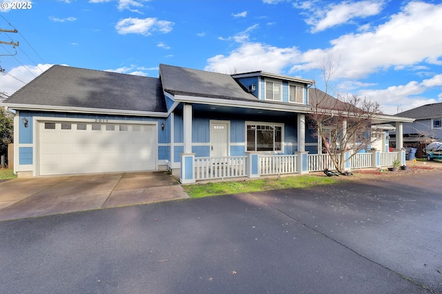 view of front of home with a garage and a porch