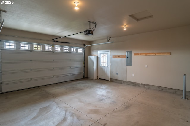 garage with electric panel, baseboards, and a garage door opener