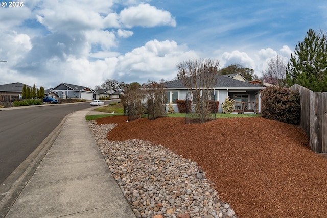 ranch-style home featuring a residential view and fence