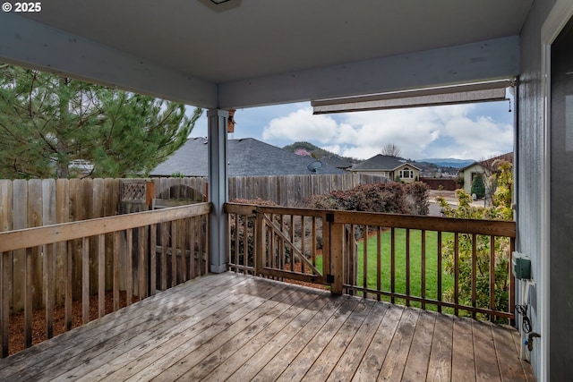 wooden terrace featuring fence