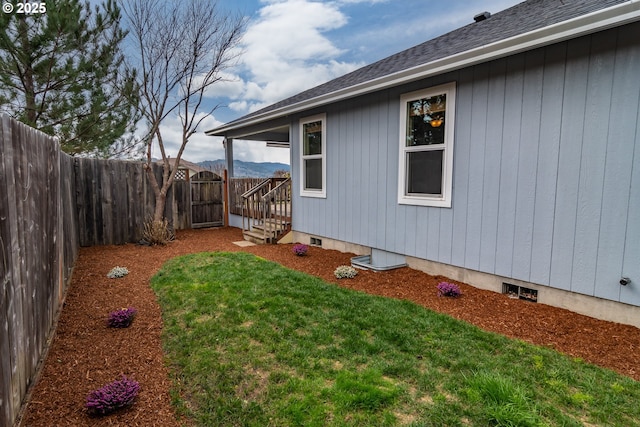 view of yard with a fenced backyard and a mountain view