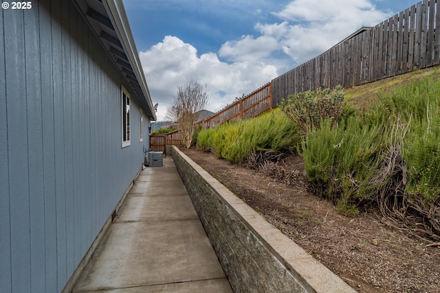 view of side of property featuring cooling unit and a fenced backyard