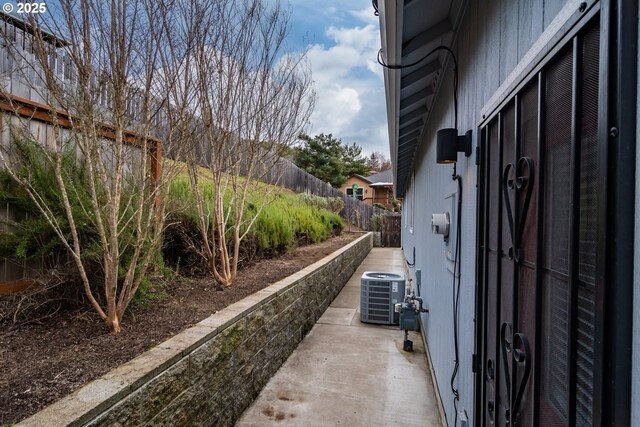 exterior space featuring cooling unit and fence