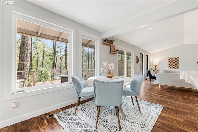 dining room featuring vaulted ceiling with beams, plenty of natural light, baseboards, and dark wood-type flooring