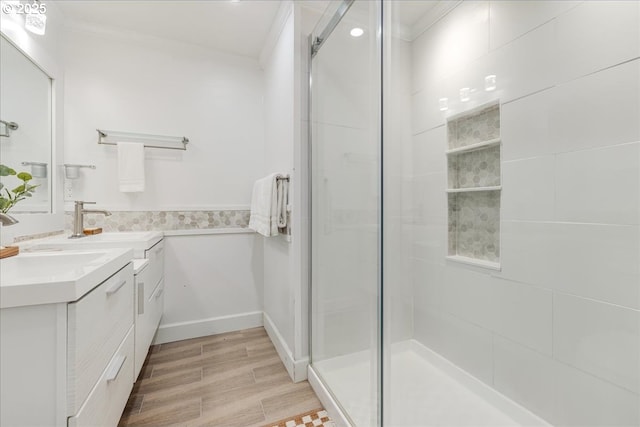 bathroom featuring ornamental molding, vanity, and a shower stall