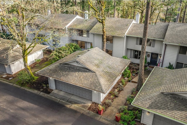 exterior space featuring roof with shingles and a chimney