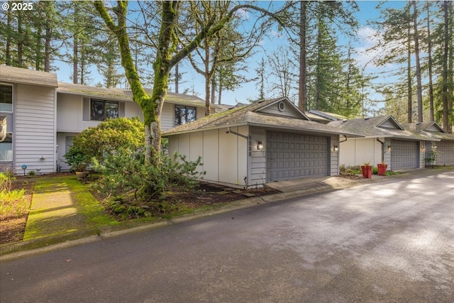 view of front of property with a garage, driveway, and board and batten siding