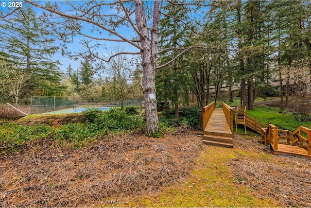 view of yard featuring a water view and fence