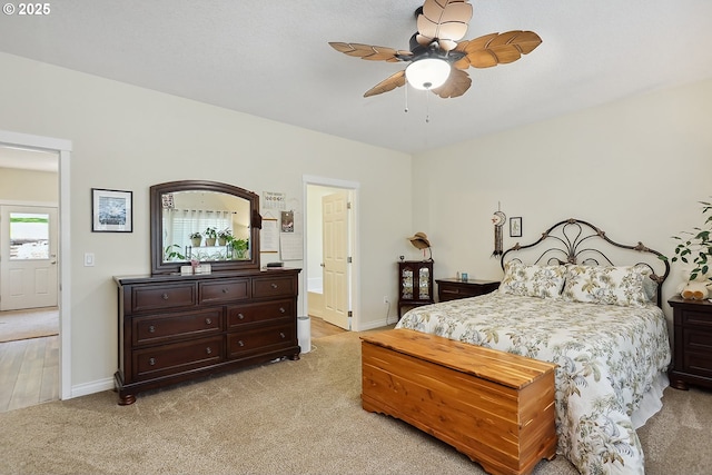bedroom with baseboards, ceiling fan, and light carpet