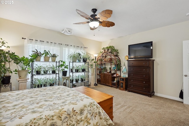 carpeted bedroom with baseboards and a ceiling fan
