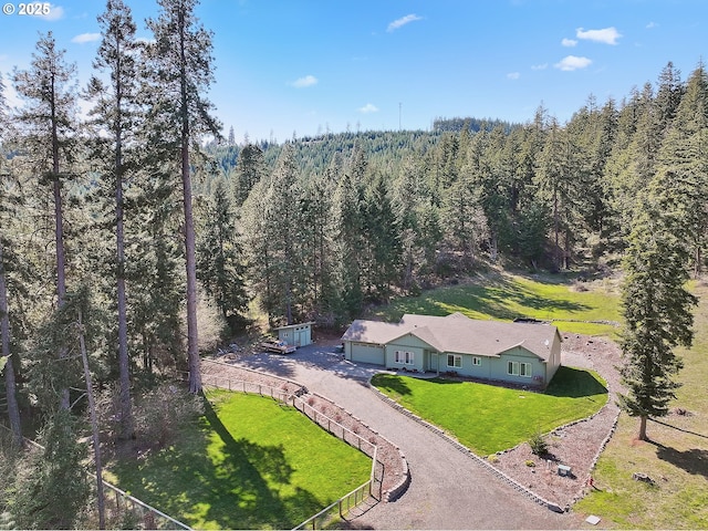 birds eye view of property with a view of trees