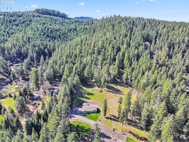 birds eye view of property with a wooded view