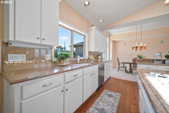1421 SE 79th Ct, Vancouver, WA 98664 - kitchen with stainless steel dishwasher, vaulted ceiling, dark wood-style floors, white cabinets, and decorative backsplash