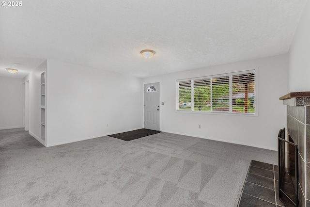 14613 NE 35th St, Vancouver, WA 98682 - unfurnished living room featuring a tiled fireplace, carpet flooring, and baseboards