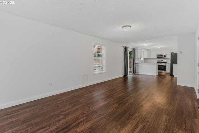 14613 NE 35th St, Vancouver, WA 98682 - unfurnished living room featuring baseboards, dark wood finished floors, and a textured ceiling