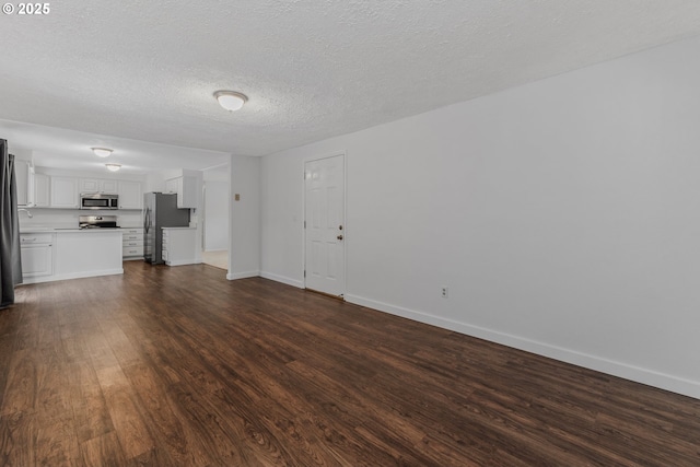14613 NE 35th St, Vancouver, WA 98682 - unfurnished living room featuring baseboards, a textured ceiling, and dark wood-style flooring