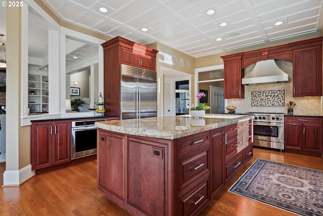 10000 NE 114th Cir, Vancouver, WA 98662 - kitchen with high quality appliances, exhaust hood, dark brown cabinets, a kitchen island, and dark wood-style floors
