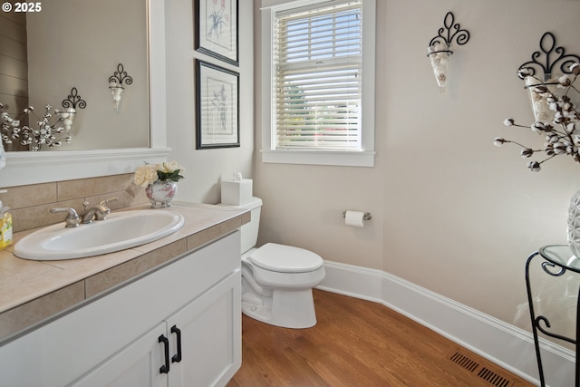 10000 NE 114th Cir, Vancouver, WA 98662 - bathroom with wood finished floors, toilet, vanity, and baseboards