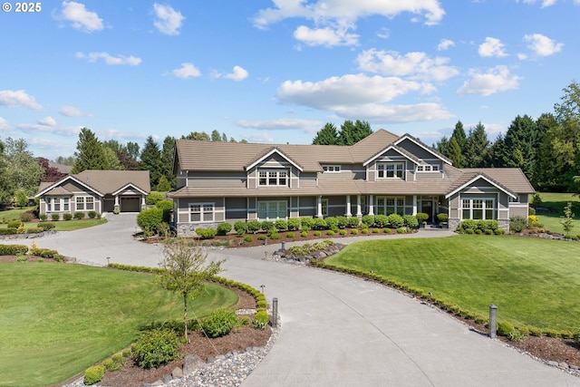10000 NE 114th Cir, Vancouver, WA 98662 - view of front of house with a front yard, curved driveway, a garage, and a tiled roof