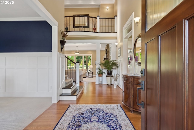 10000 NE 114th Cir, Vancouver, WA 98662 - entrance foyer featuring stairway, crown molding, wood finished floors, a high ceiling, and a decorative wall