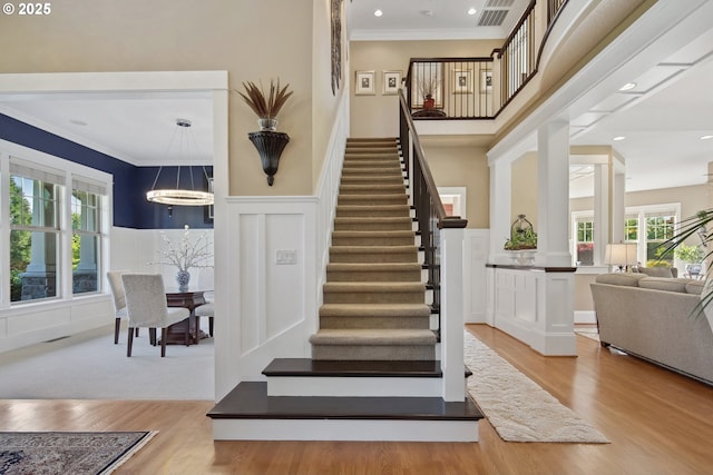 10000 NE 114th Cir, Vancouver, WA 98662 - stairs featuring crown molding, plenty of natural light, wood finished floors, a decorative wall, and wainscoting