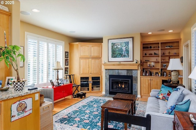 725 E Ave, Lake Oswego, OR 97034 - living area featuring wood finished floors, a tiled fireplace, and recessed lighting