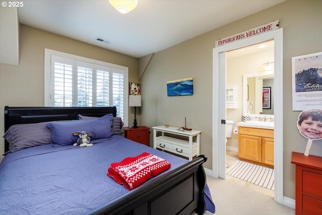 725 E Ave, Lake Oswego, OR 97034 - bedroom featuring light colored carpet, ensuite bath, baseboards, and a sink