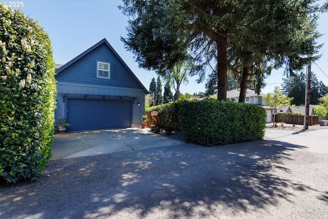 725 E Ave, Lake Oswego, OR 97034 - view of side of home with fence, board and batten siding, and a garage