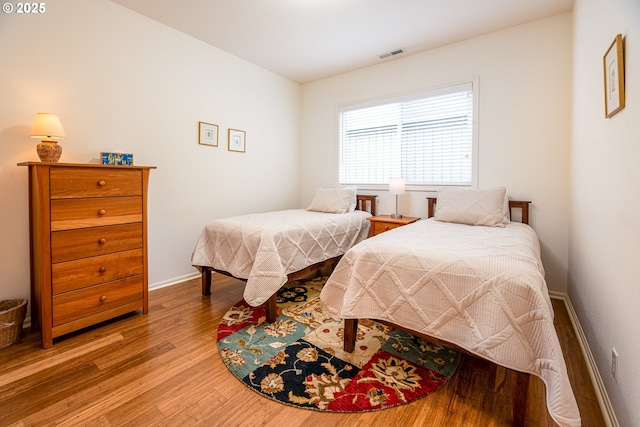 bedroom with wood-type flooring