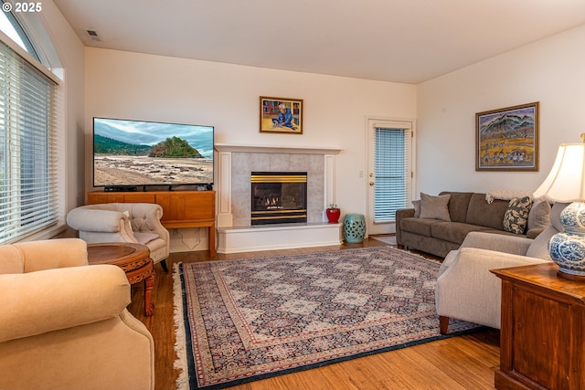 living room with a premium fireplace and hardwood / wood-style floors